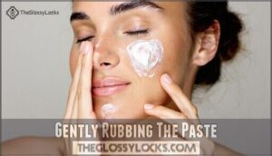 gently rubbing the paste