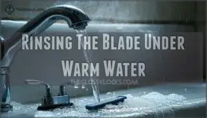 rinsing the blade under warm water
